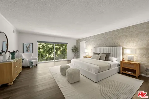 a bedroom with a large bed and a couch