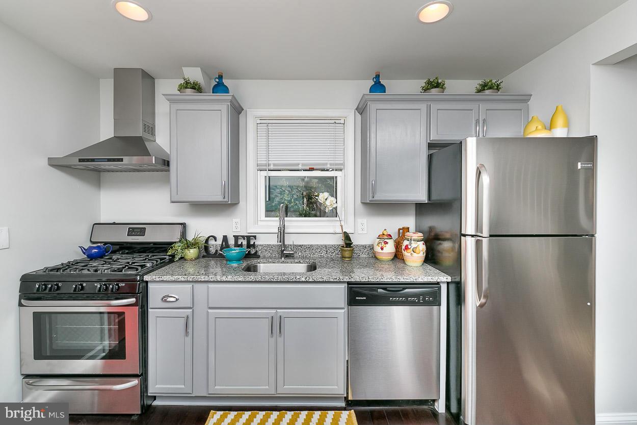 1816 Forrest Road Baltimore, MD 21234 - Photo 7 of 19 a kitchen with stainless steel appliances granite countertop a refrigerator stove and sink