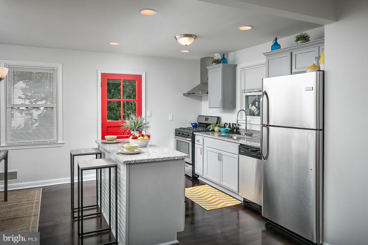1816 Forrest Road Baltimore, MD 21234 - Photo 8 of 19 a kitchen with stainless steel appliances granite countertop a refrigerator sink stove and microwave