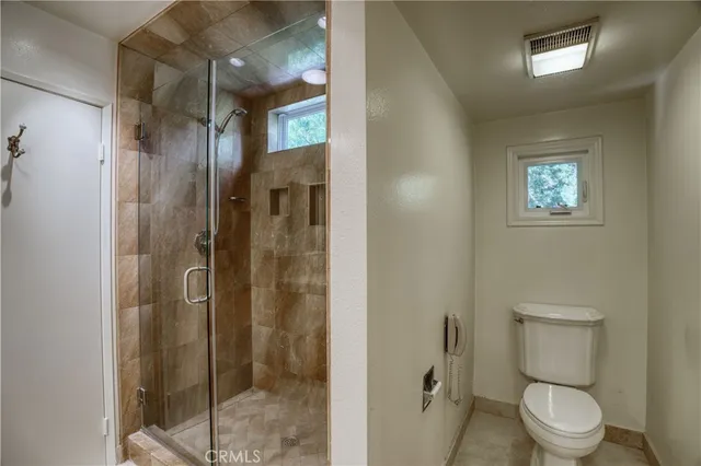 a bathroom with a toilet and a shower