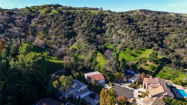 an aerial view of a house with a yard