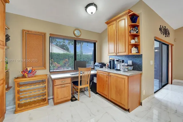 a bathroom with a granite countertop sink mirror vanity and toilet