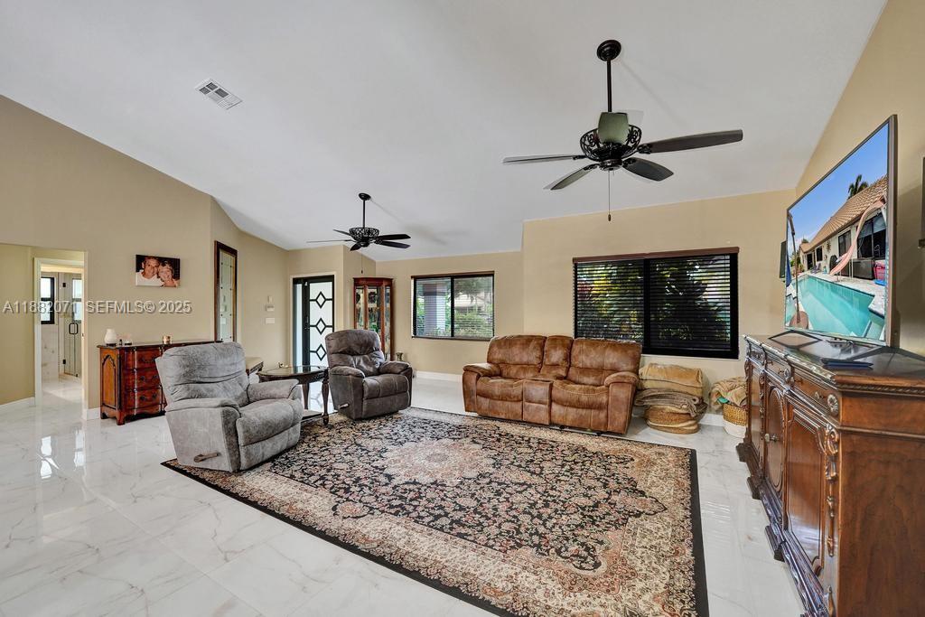 3187 Beechberry Circle Davie, FL 33328 - Photo 12 of 20 a living room with furniture and a flat screen tv