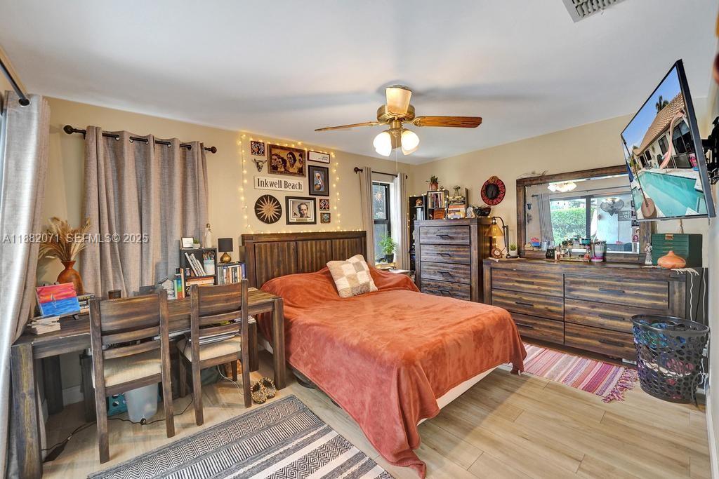 3187 Beechberry Circle Davie, FL 33328 - Photo 14 of 20 a bedroom with a bed and a chandelier