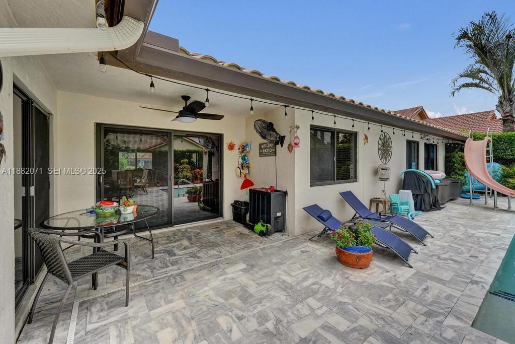 3187 Beechberry Circle Davie, FL 33328 - Photo 7 of 20 a view of a chair and tables in the patio