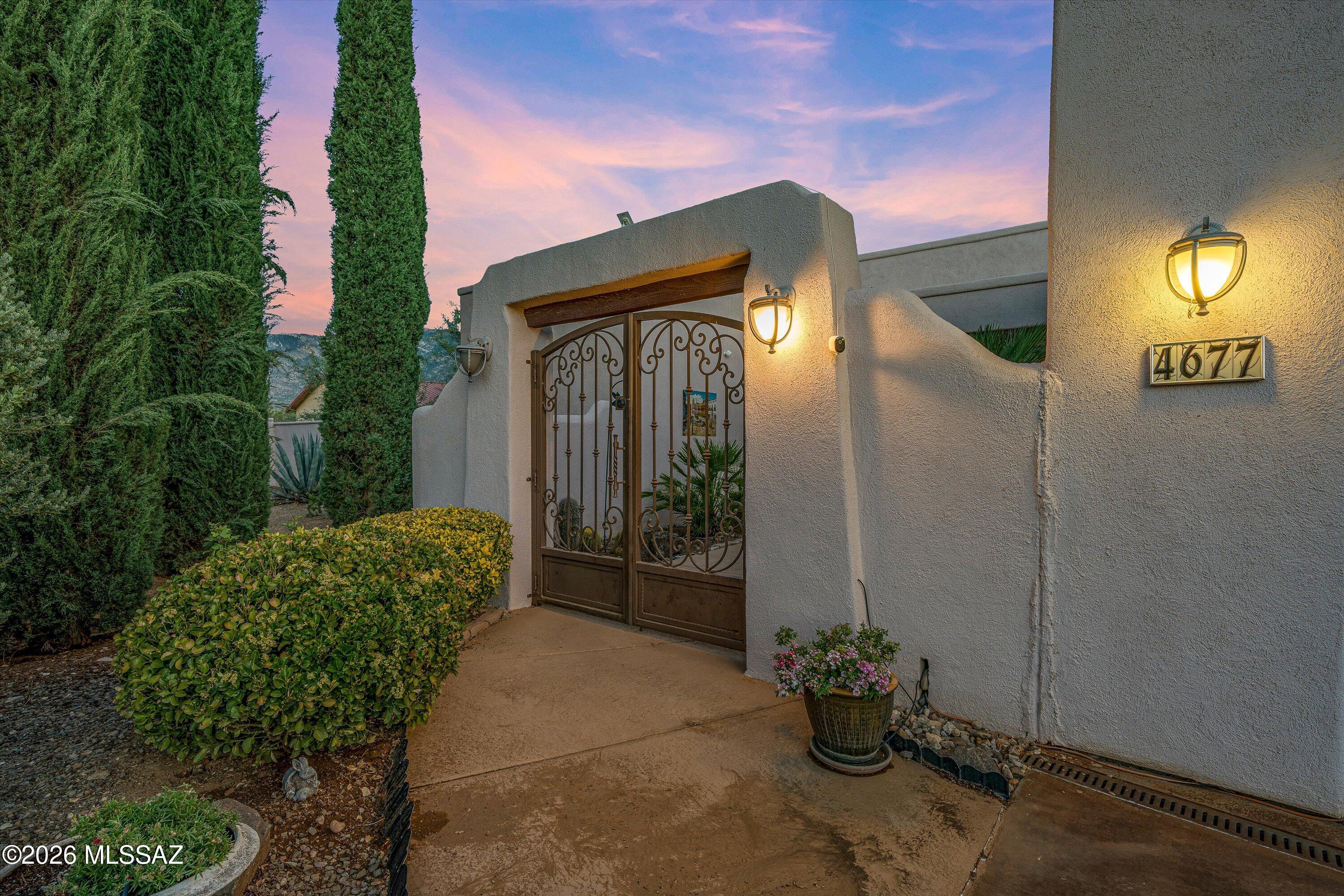 4677 East Rail N Road Tucson, AZ 85739 - Photo 41 of 48 Secure gated entrance to courtyard beside the 3 car attached garage