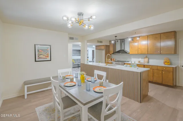 an empty room with wooden floor and ceiling fan