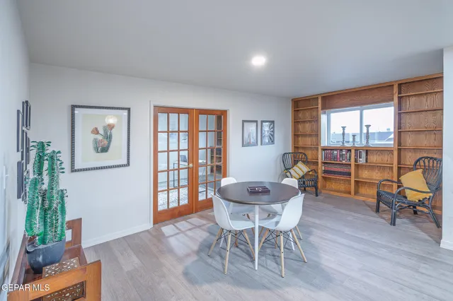 a kitchen with kitchen island granite countertop a sink stove and cabinets