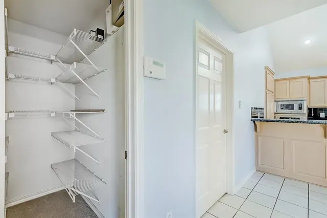 a kitchen with white cabinets and white appliances