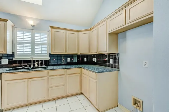 a view of a kitchen with granite countertop white cabinets and a sink