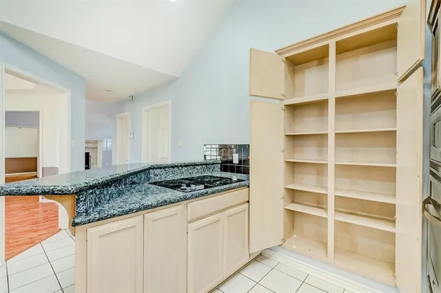 a kitchen with granite countertop a stove and a cabinets