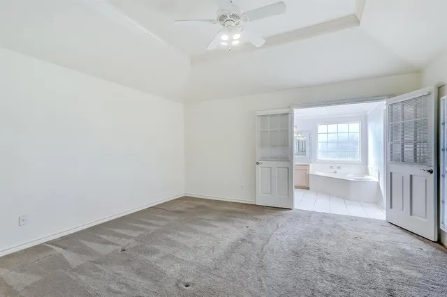 an empty room with a cabinet and mirrors