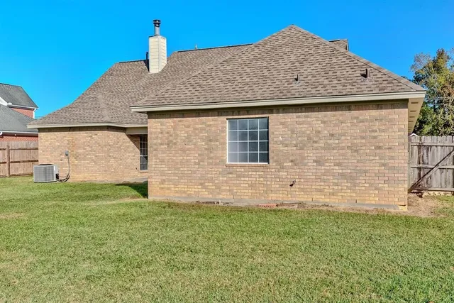 a view of a house with a yard and sitting area
