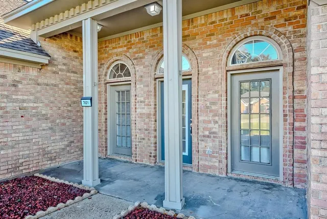 a view of a door with a brick wall