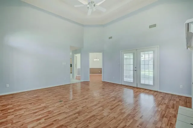 wooden floor in an empty room with a window