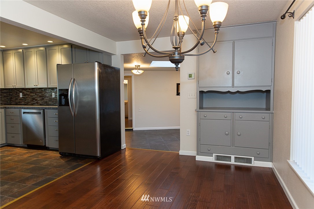 23605 5th Avenue West Bothell, WA 98021 - Photo 11 of 20 a kitchen with granite countertop a refrigerator and a stove top oven