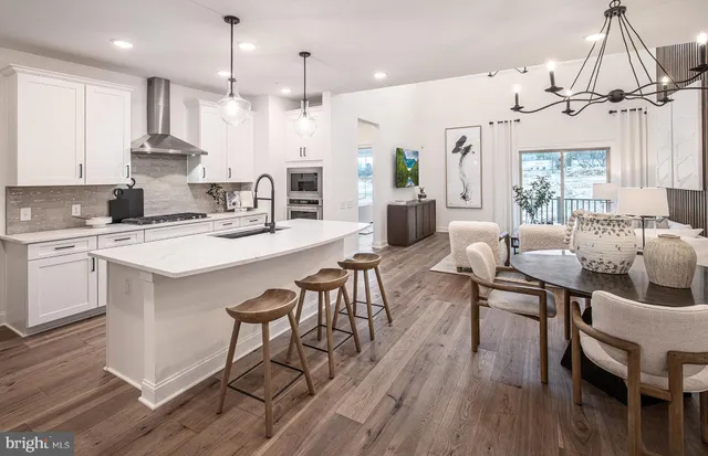 a large kitchen with a table and chairs