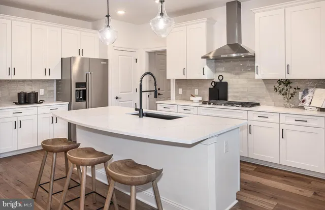 a kitchen with a white center island and appliances