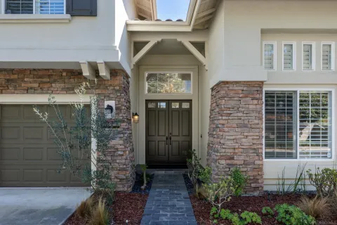a front view of a house with a garden