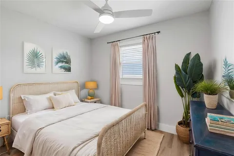 a bedroom with bed and a potted plant