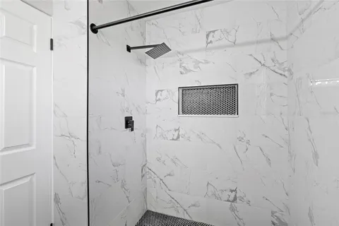 a bathroom with a shower and a sink