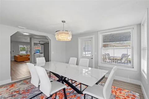 a view of a dining room with furniture and a chandelier