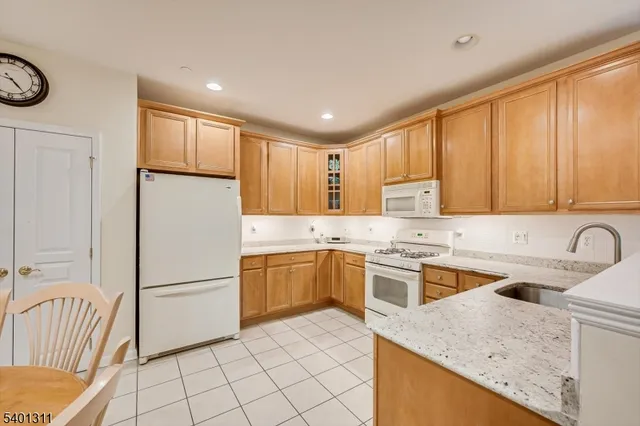 a kitchen with a sink a stove a refrigerator and cabinets