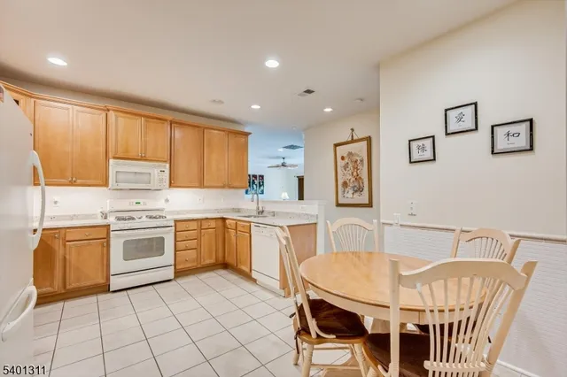 a kitchen with a table chairs stove and cabinets
