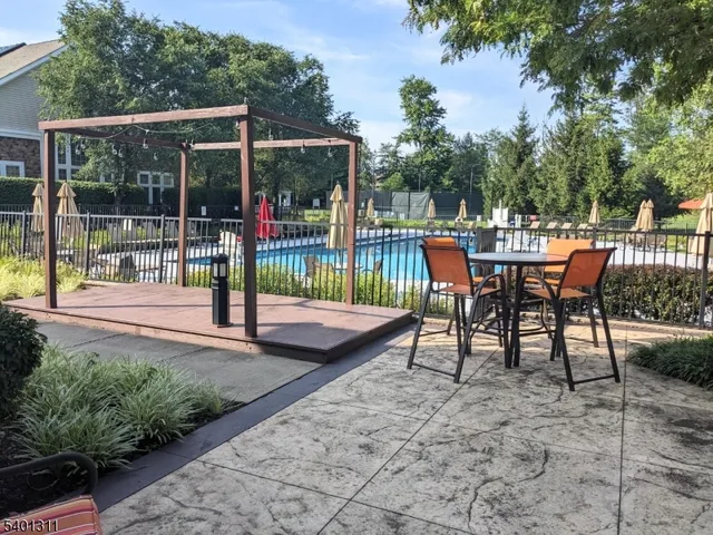 a view of a patio with a table chairs and a backyard