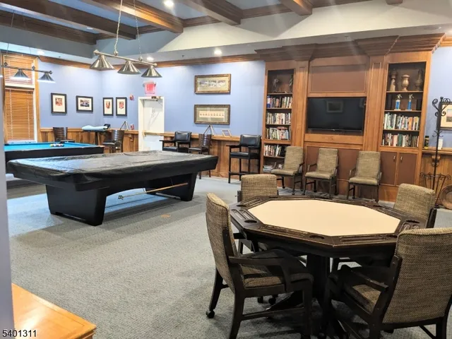 a living room with a table chairs and a dining table