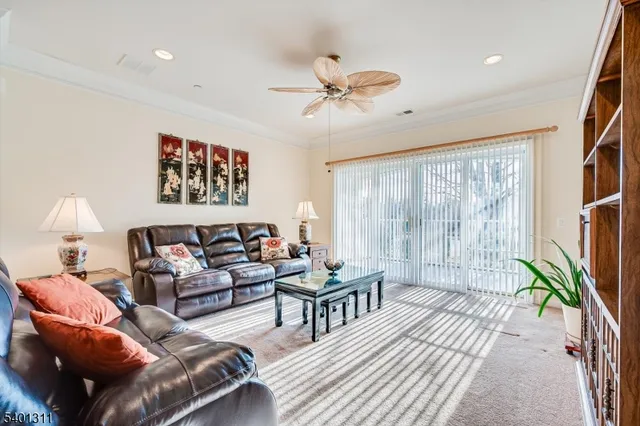 a living room with furniture a chandelier and a large window