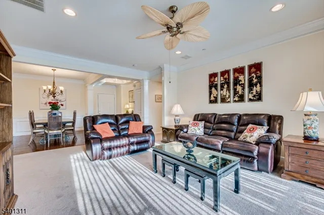 a living room with furniture a rug and a chandelier
