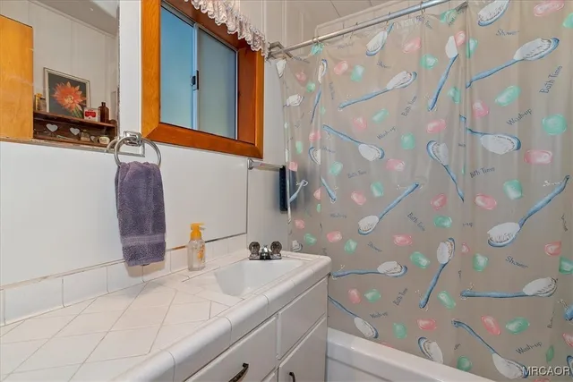 a roof deck with couches and wooden fence