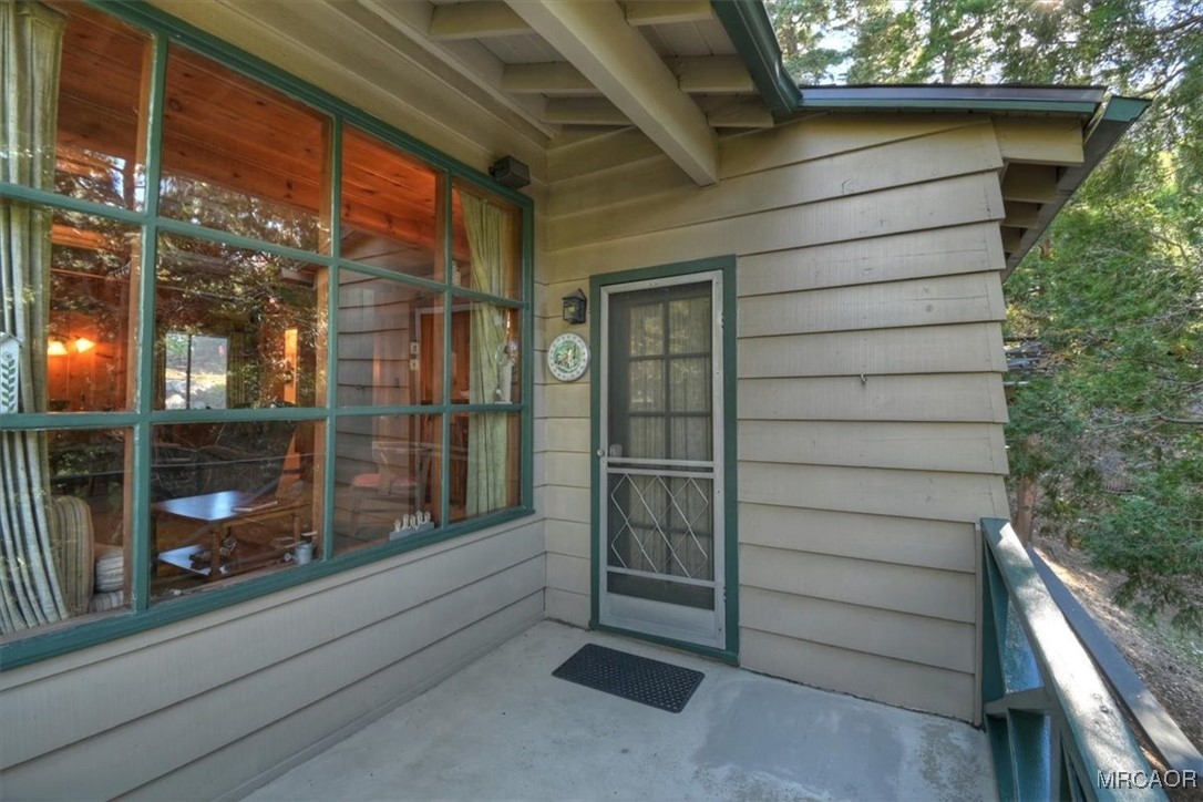 620 Cedar Lane Twin Peaks, CA 92391 - Photo 24 of 31 a view of a house with a door and a porch