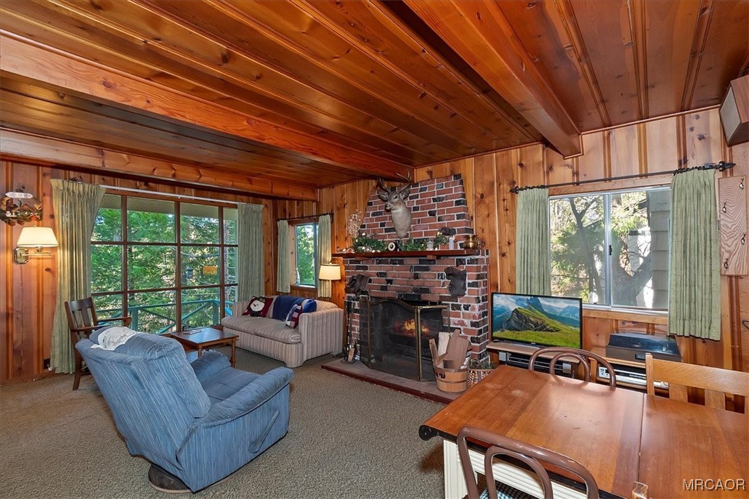 620 Cedar Lane Twin Peaks, CA 92391 - Photo 7 of 31 a living room with furniture a fireplace and floor to ceiling window