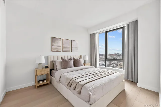 a bedroom with a bed and a large window