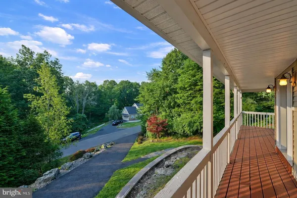 a view of a balcony with yard