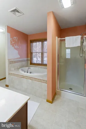 a spacious bathroom with a tub and shower