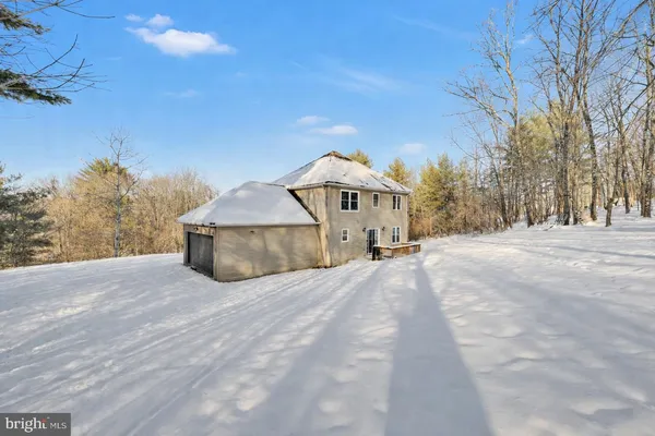 a view of a house with a snow in the yard