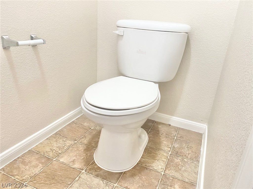 8569 Rhamus Court Las Vegas, NV 89149 - Photo 31 of 35 A well-kept powder room showcases durable tile flooring and a standard commode.