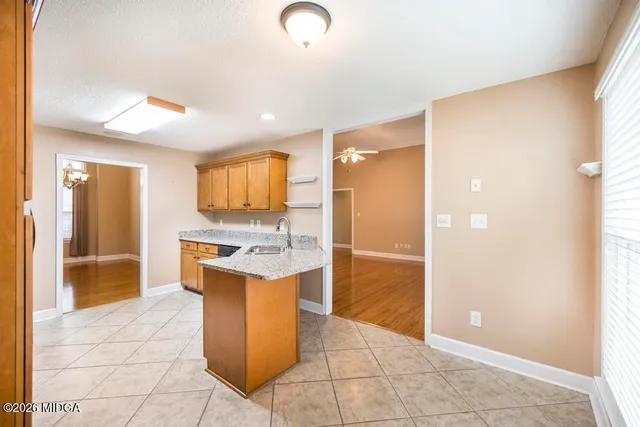a kitchen with stainless steel appliances granite countertop a sink and a refrigerator