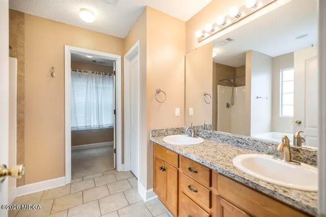 a spacious bathroom with a double vanity sink mirror and double