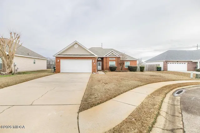 a front view of a house with a garden and entryway