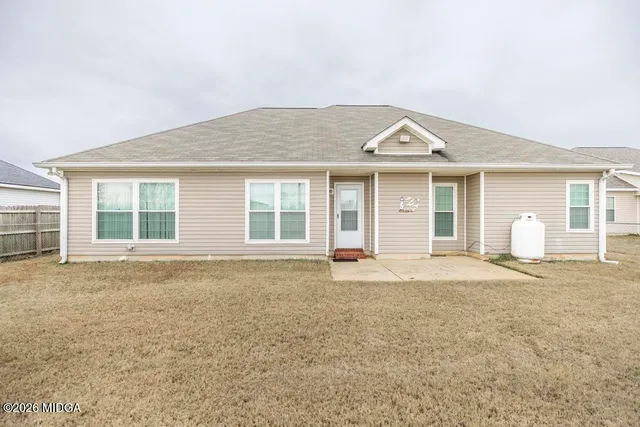 a view of a house with a backyard and windows