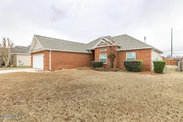a front view of a house with a garden