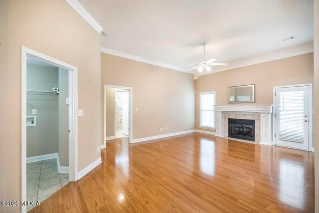 a view of a livingroom with wooden floor and a fireplace