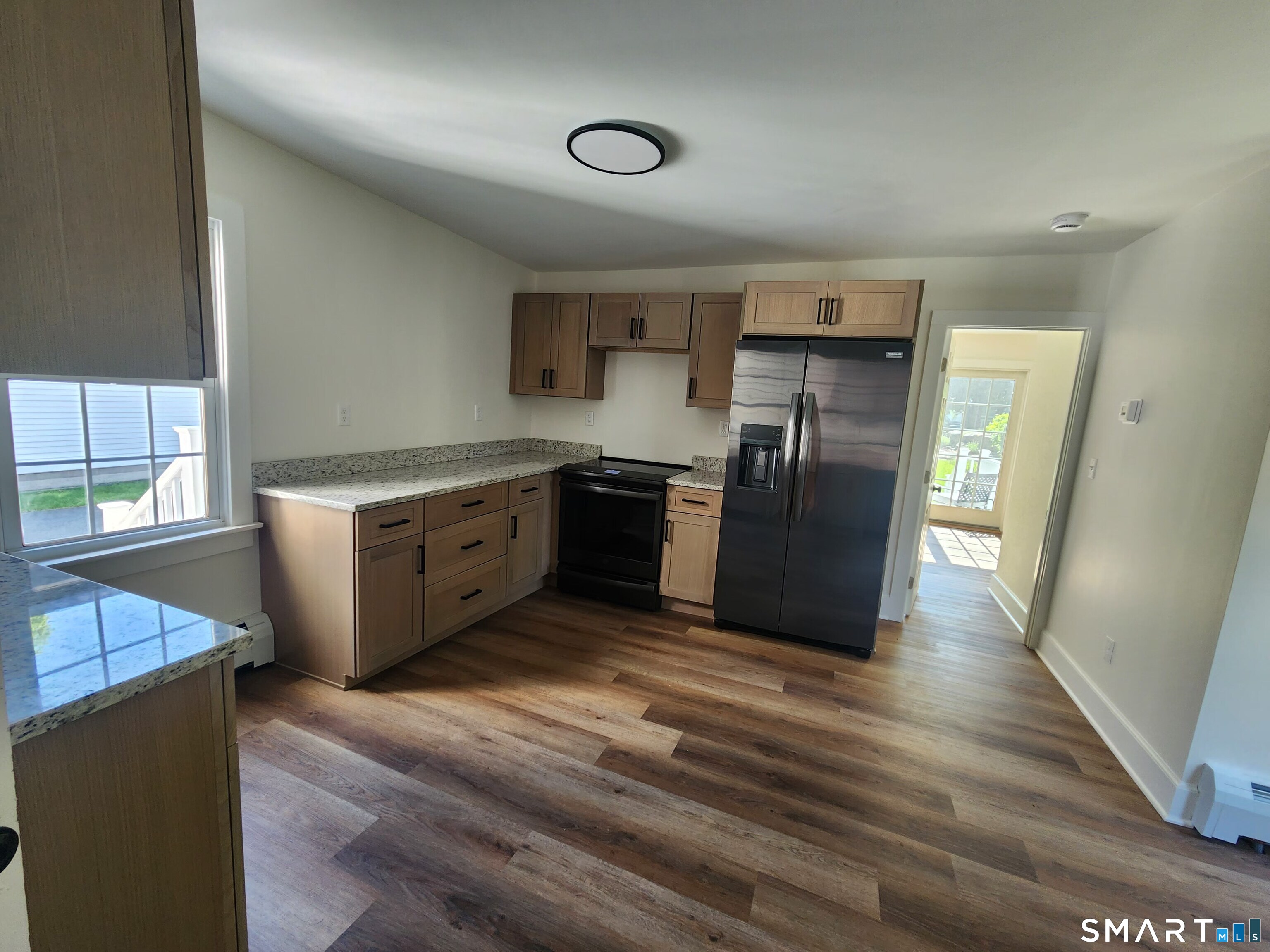 82 State Street, Unit 1 Guilford, CT 06437 - Photo 4 of 9 a kitchen with stainless steel appliances granite countertop a refrigerator and a stove