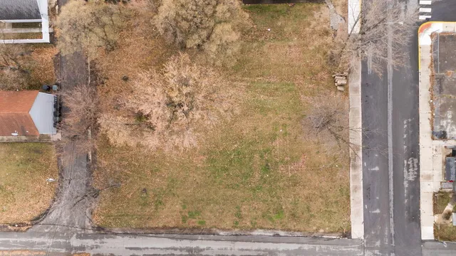 an aerial view of residential houses with yard