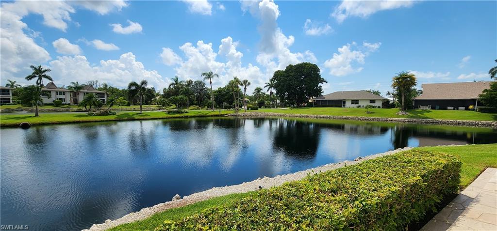 102 Georgetown Boulevard, Unit 102 Naples, FL 34112 - Photo 1 of 29 a view of a lake with a house
