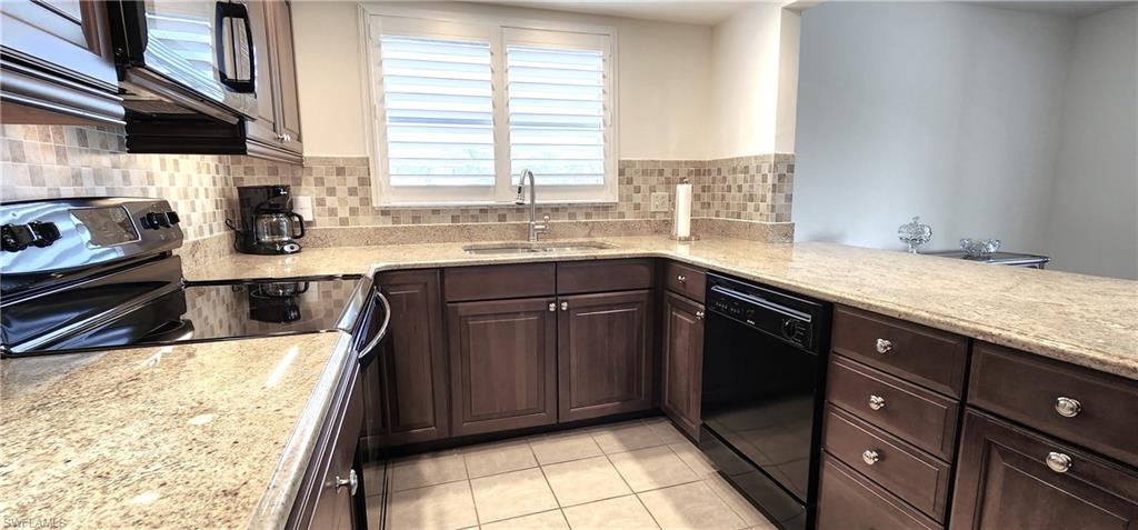 102 Georgetown Boulevard, Unit 102 Naples, FL 34112 - Photo 11 of 29 a kitchen with a sink and a window